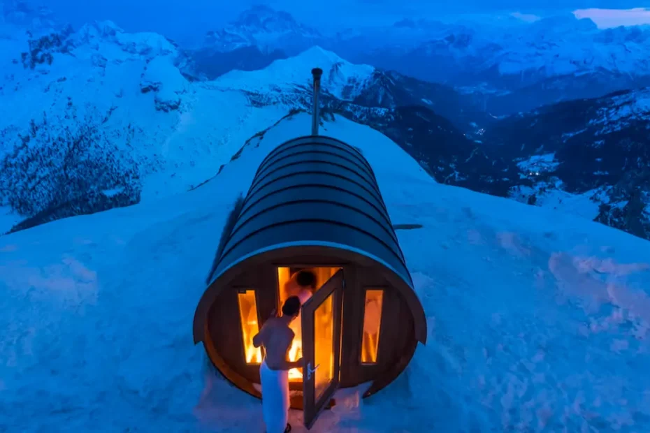 Couple entering a sauna on top of a mountain with blue tones. They are thinking of applying for a dependent visa.