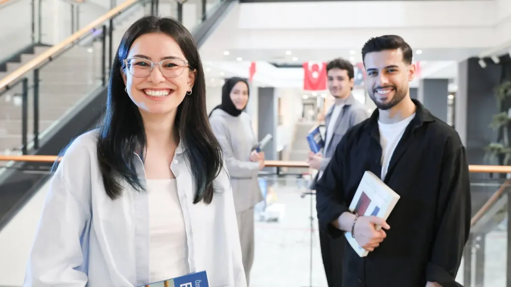 Ofis &ccedil;alışanları g&uuml;l&uuml;mseyen bir kadın ve erkek. HANGİ VİZE BANA UYGUN